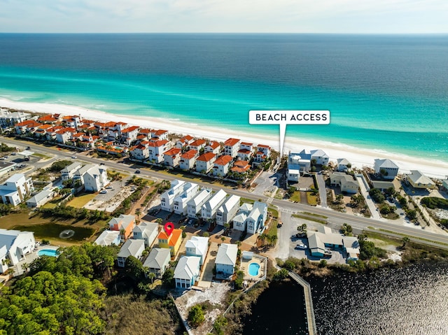 birds eye view of property with a view of the beach, a residential view, and a water view