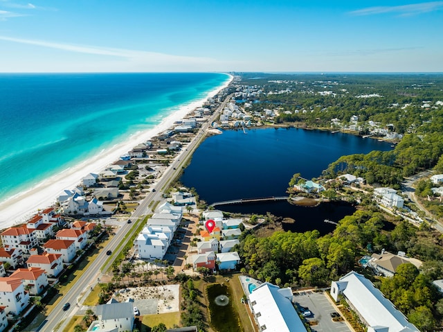 aerial view with a water view and a view of the beach