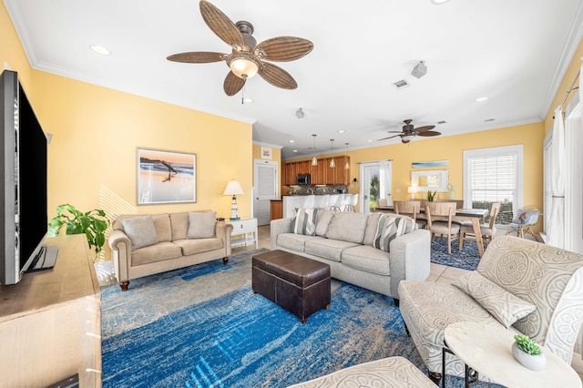 living area with ornamental molding and recessed lighting