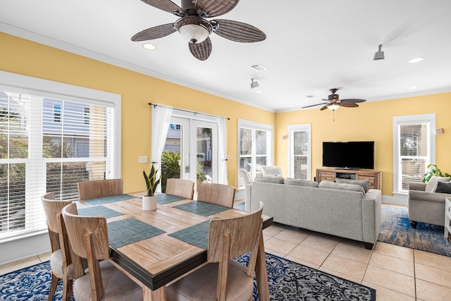 dining space featuring light tile patterned floors, visible vents, ornamental molding, french doors, and a wealth of natural light