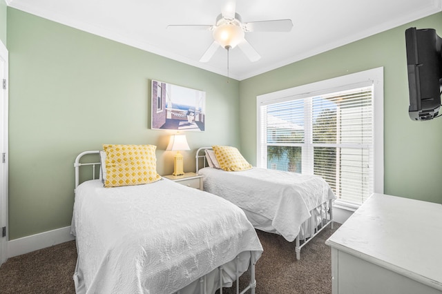 bedroom with ornamental molding, dark carpet, baseboards, and a ceiling fan