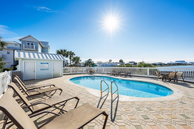 pool with fence and a patio