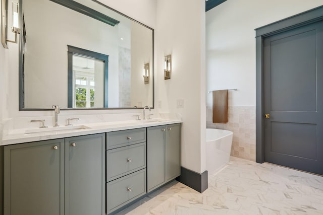 215 Buddy St, Santa Rosa Beach, FL 32459 - full bath with a freestanding tub, marble finish flooring, double vanity, tile walls, and a wainscoted wall