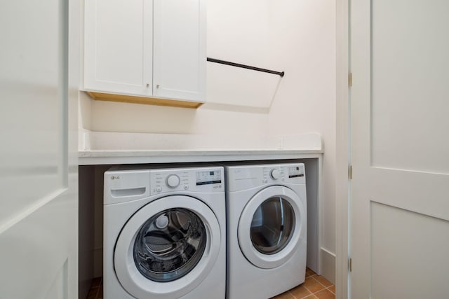 215 Buddy St, Santa Rosa Beach, FL 32459 - laundry area featuring washer and clothes dryer, cabinet space, and tile patterned flooring