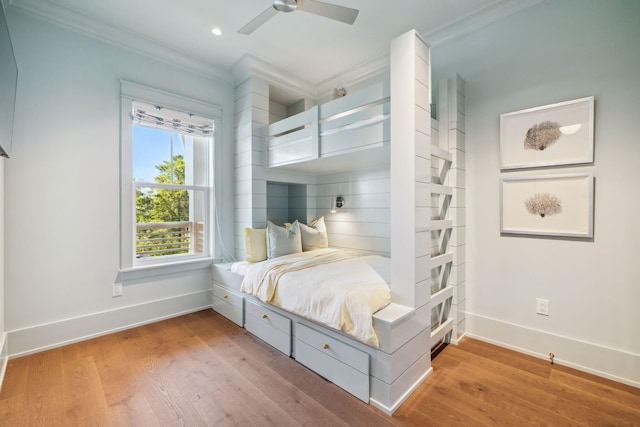 215 Buddy St, Santa Rosa Beach, FL 32459 - bedroom featuring baseboards, crown molding, light wood-style flooring, and a ceiling fan