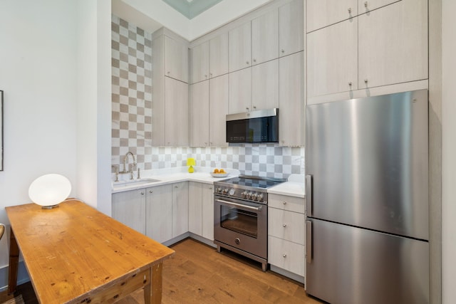 215 Buddy St, Santa Rosa Beach, FL 32459 - kitchen with stainless steel appliances, a sink, light wood-style flooring, light countertops, and backsplash