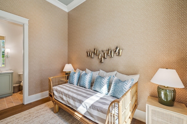 215 Buddy St, Santa Rosa Beach, FL 32459 - bedroom with wood finished floors, baseboards, ornamental molding, and connected bathroom