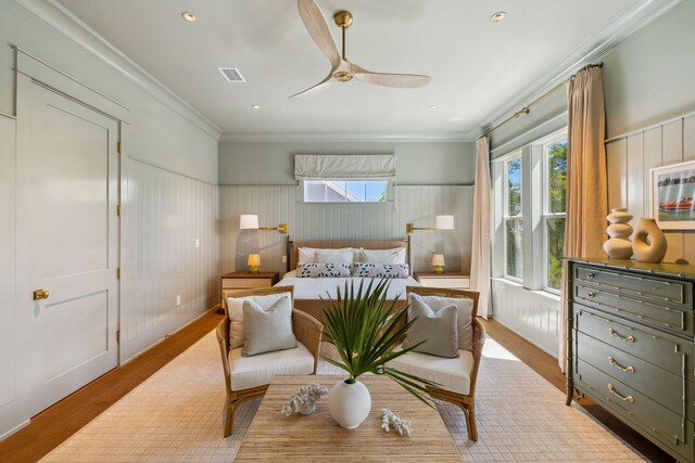 215 Buddy St, Santa Rosa Beach, FL 32459 - bedroom featuring multiple windows, wood finished floors, ornamental molding, a wainscoted wall, and ceiling fan