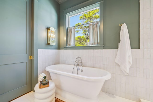 215 Buddy St, Santa Rosa Beach, FL 32459 - bathroom with tile walls, a soaking tub, and wainscoting