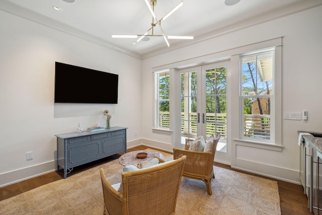 215 Buddy St, Santa Rosa Beach, FL 32459 - living area featuring baseboards, a chandelier, wood finished floors, and ornamental molding