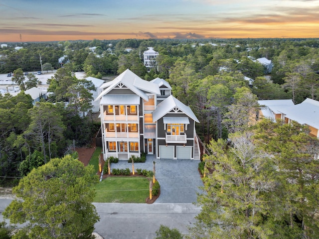 215 Buddy St, Santa Rosa Beach, FL 32459 - view of front of property featuring an attached garage, stairs, concrete driveway, a balcony, and metal roof