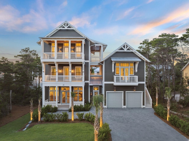215 Buddy St, Santa Rosa Beach, FL 32459 - beach home featuring a balcony, decorative driveway, an attached garage, french doors, and a front lawn
