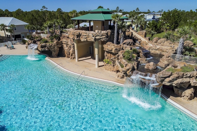 pool featuring a gazebo and fence