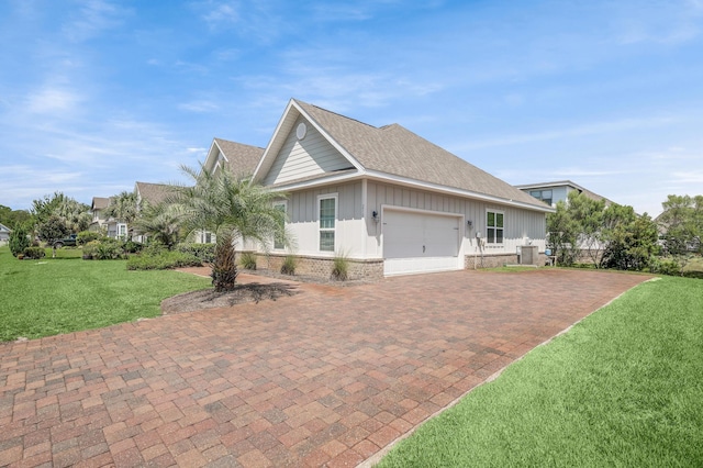 view of property exterior with a garage, decorative driveway, a yard, board and batten siding, and brick siding