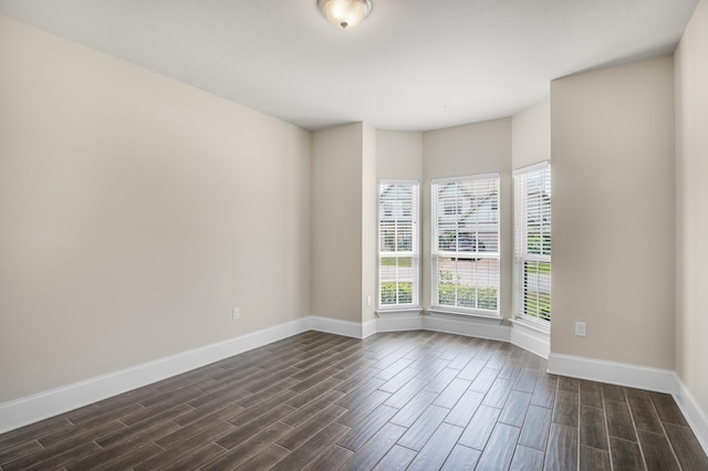 empty room with wood finish floors and baseboards