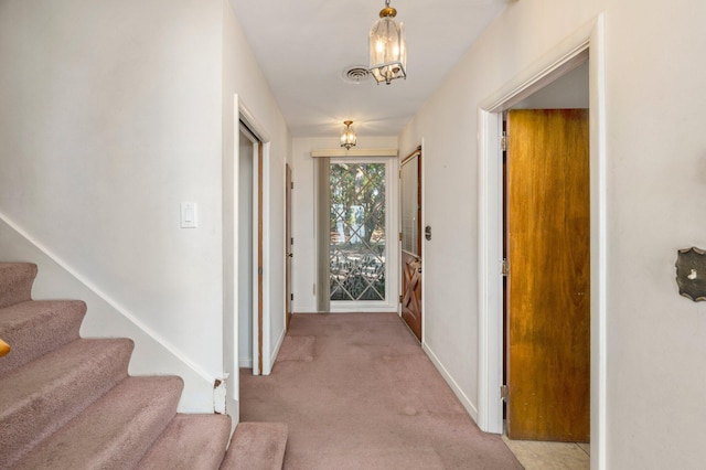 hall with light colored carpet