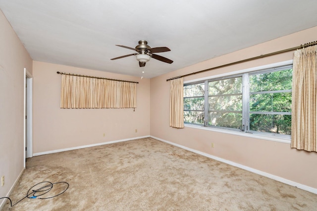 unfurnished room featuring ceiling fan and carpet flooring