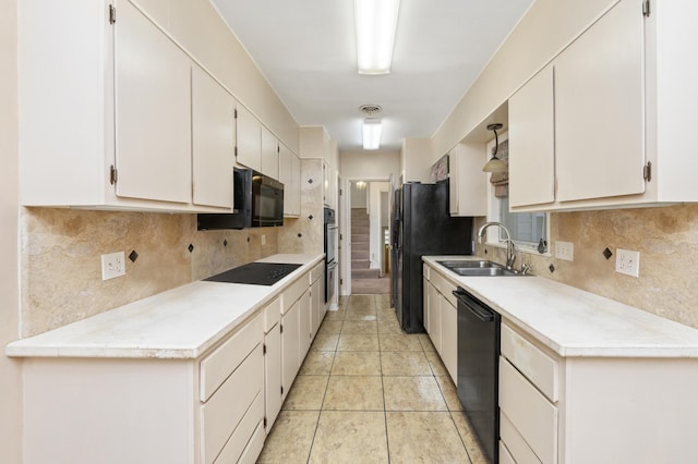 kitchen with decorative backsplash, sink, white cabinets, and black appliances