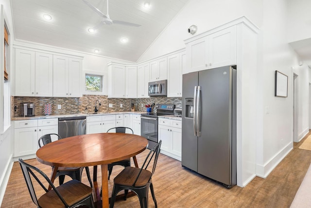 kitchen with stainless steel appliances, light countertops, and white cabinets