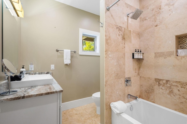 full bathroom featuring bathing tub / shower combination, toilet, vanity, tile patterned flooring, and baseboards