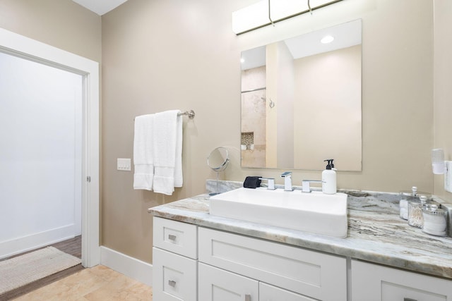 bathroom with vanity and baseboards