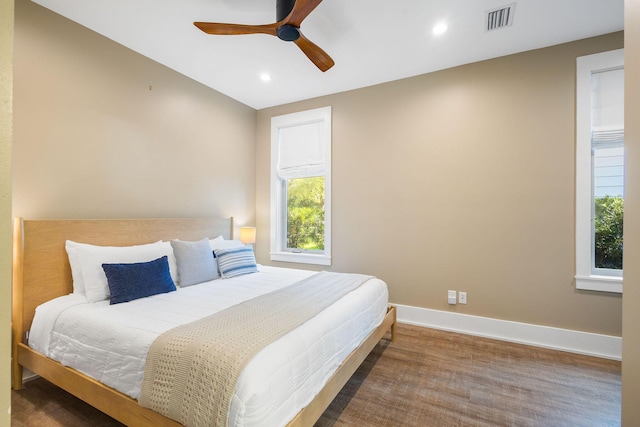 bedroom with ceiling fan, recessed lighting, wood finished floors, visible vents, and baseboards