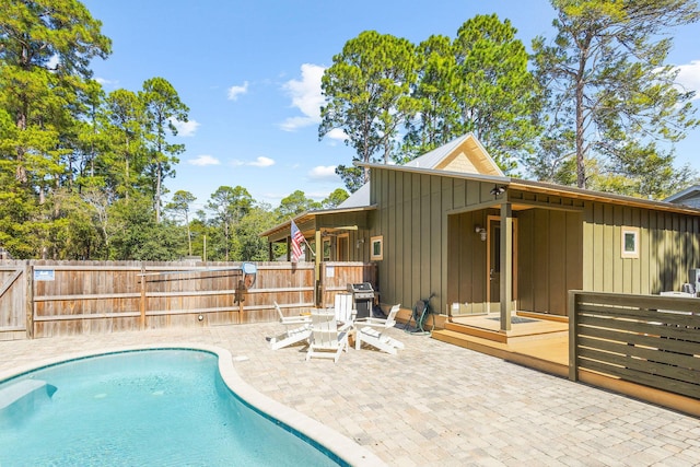 view of pool with a fenced in pool, a patio area, and fence