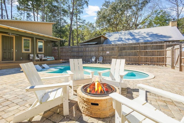 view of swimming pool featuring a patio area, an outdoor fire pit, a fenced in pool, and a fenced backyard