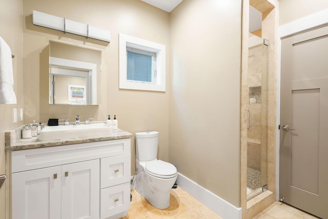 bathroom with toilet, a stall shower, vanity, baseboards, and tile patterned floors