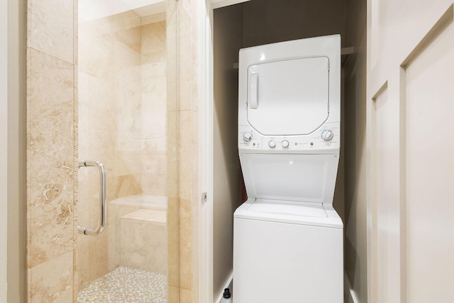 washroom with laundry area and stacked washer / drying machine