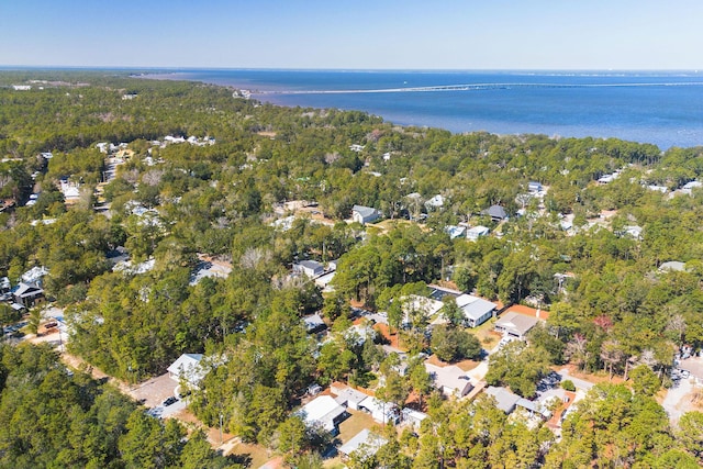 birds eye view of property featuring a water view and a view of trees