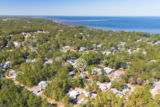 drone / aerial view featuring a water view and a wooded view