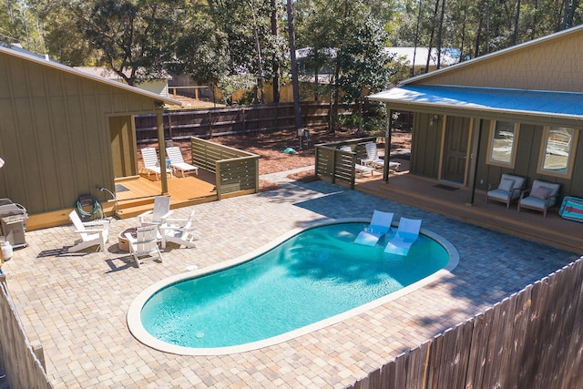 view of pool featuring a deck, a fenced backyard, and a fenced in pool