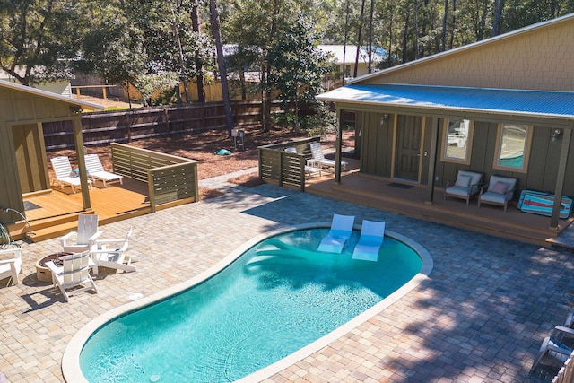 view of pool with a deck, a patio, fence, and a fenced in pool