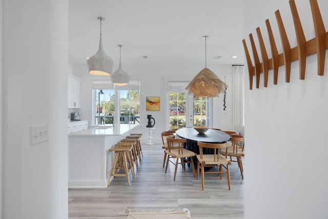 dining room with light wood-type flooring and recessed lighting