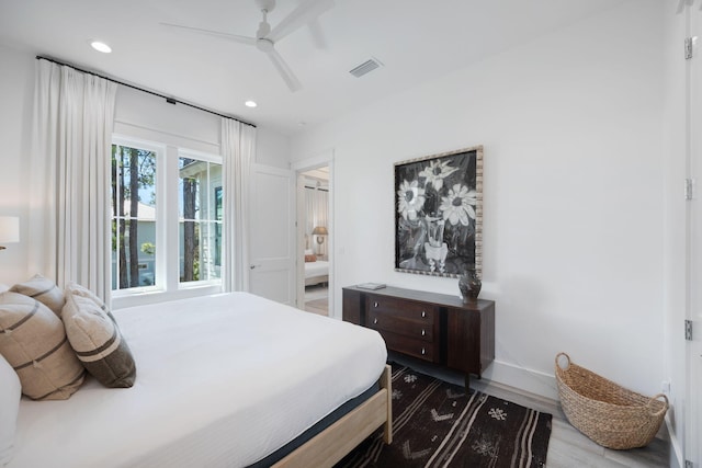 bedroom featuring baseboards, visible vents, a ceiling fan, wood finished floors, and recessed lighting