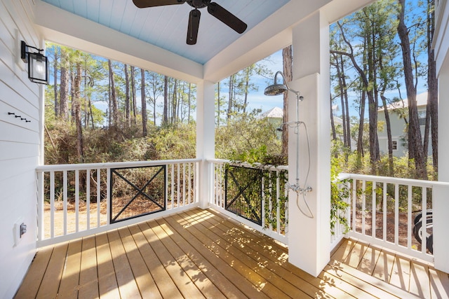 wooden terrace featuring a ceiling fan