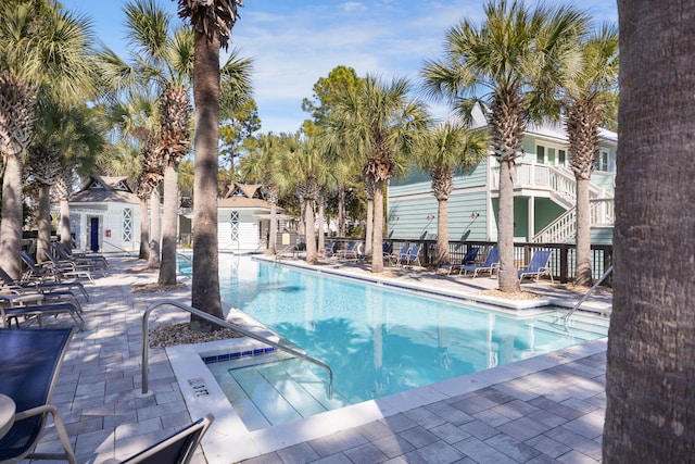 community pool featuring an outbuilding, a patio, and an exterior structure