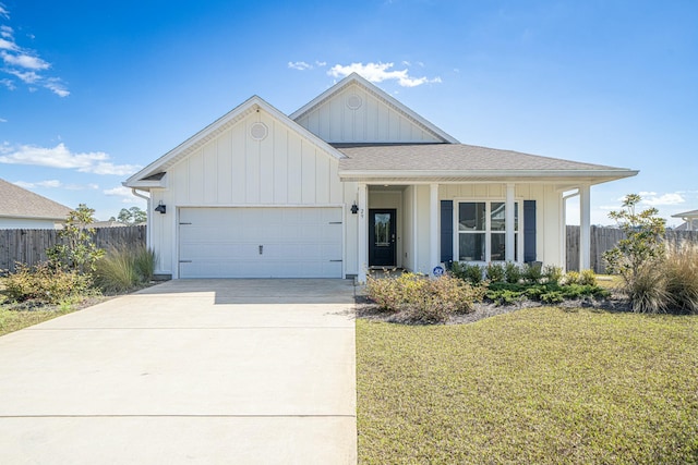 view of front of property with a front yard and a garage