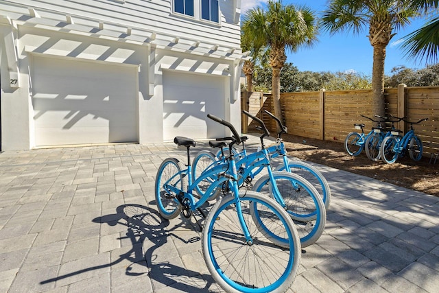 view of patio featuring a garage and fence