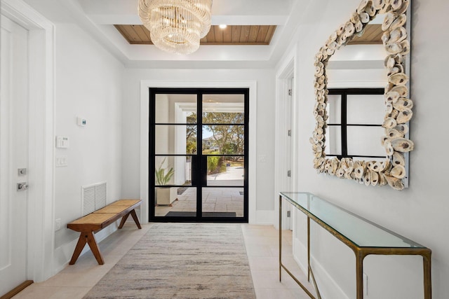 foyer with tile patterned flooring, a chandelier, wood ceiling, and visible vents