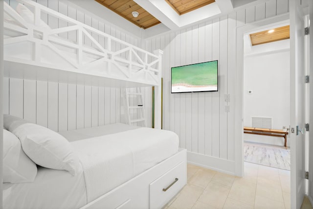 bedroom featuring a skylight, visible vents, wood ceiling, and light tile patterned flooring