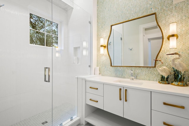 bathroom featuring tasteful backsplash, tile walls, a stall shower, and vanity