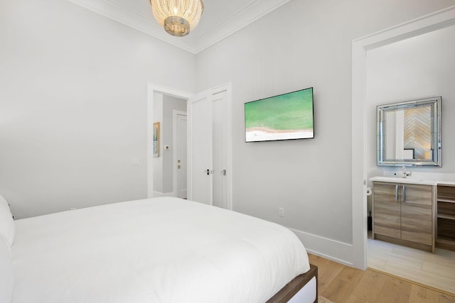 bedroom featuring baseboards, light wood-style floors, and ornamental molding