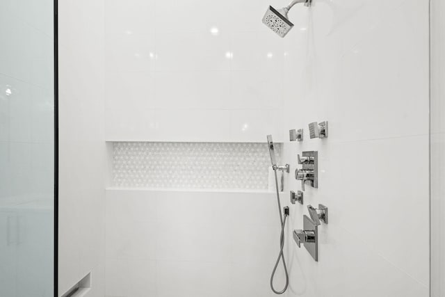 full bath with a tile shower