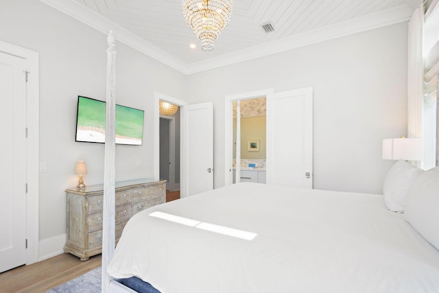 bedroom with visible vents, light wood-style floors, ornamental molding, and a chandelier