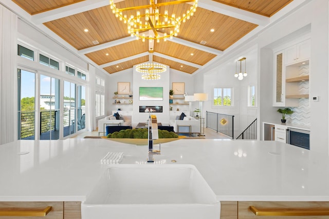 kitchen with wooden ceiling, beamed ceiling, a notable chandelier, and tasteful backsplash