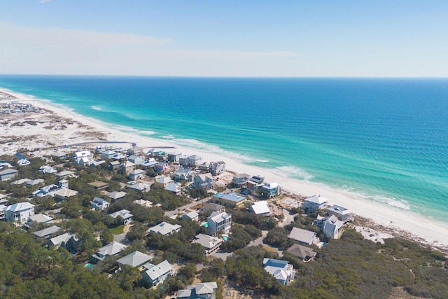 drone / aerial view featuring a water view and a beach view