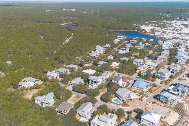 aerial view with a forest view and a water view