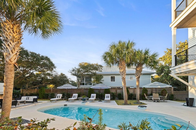 view of pool featuring a patio area, a fenced in pool, and a fenced backyard